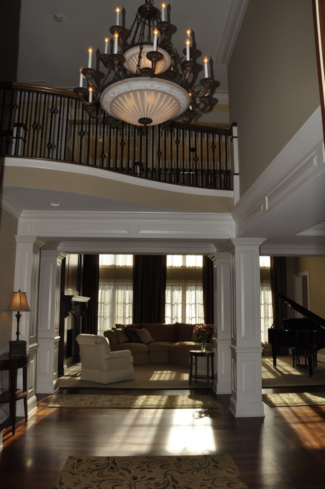Inspiration for an expansive transitional foyer in Cincinnati with yellow walls, dark hardwood floors, a single front door and a dark wood front door.