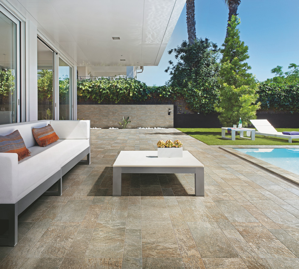 Large transitional courtyard tile and rectangular natural pool photo in Denver