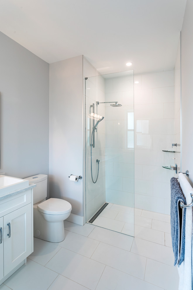 This is an example of a mid-sized traditional master bathroom in Vancouver with shaker cabinets, white cabinets, an alcove shower, a two-piece toilet, white tile, ceramic tile, grey walls, ceramic floors, a vessel sink, laminate benchtops, white floor, an open shower, white benchtops, a double vanity and a built-in vanity.