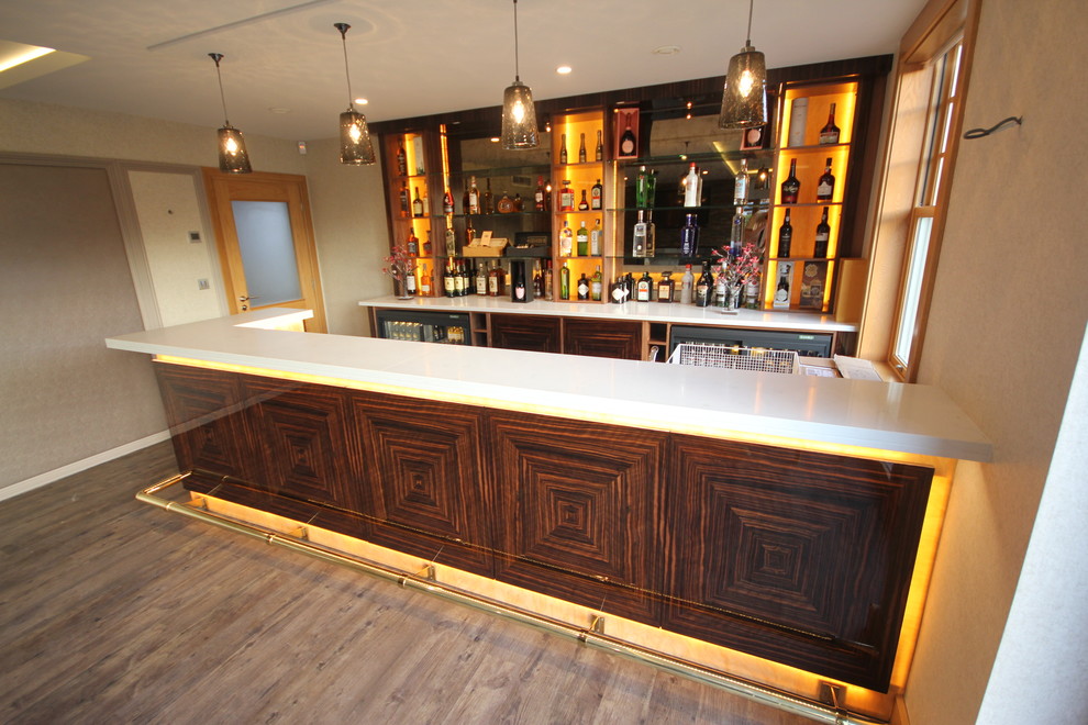 Photo of a large modern l-shaped wet bar in Cheshire with an undermount sink, flat-panel cabinets, dark wood cabinets, quartz benchtops, beige splashback and painted wood floors.