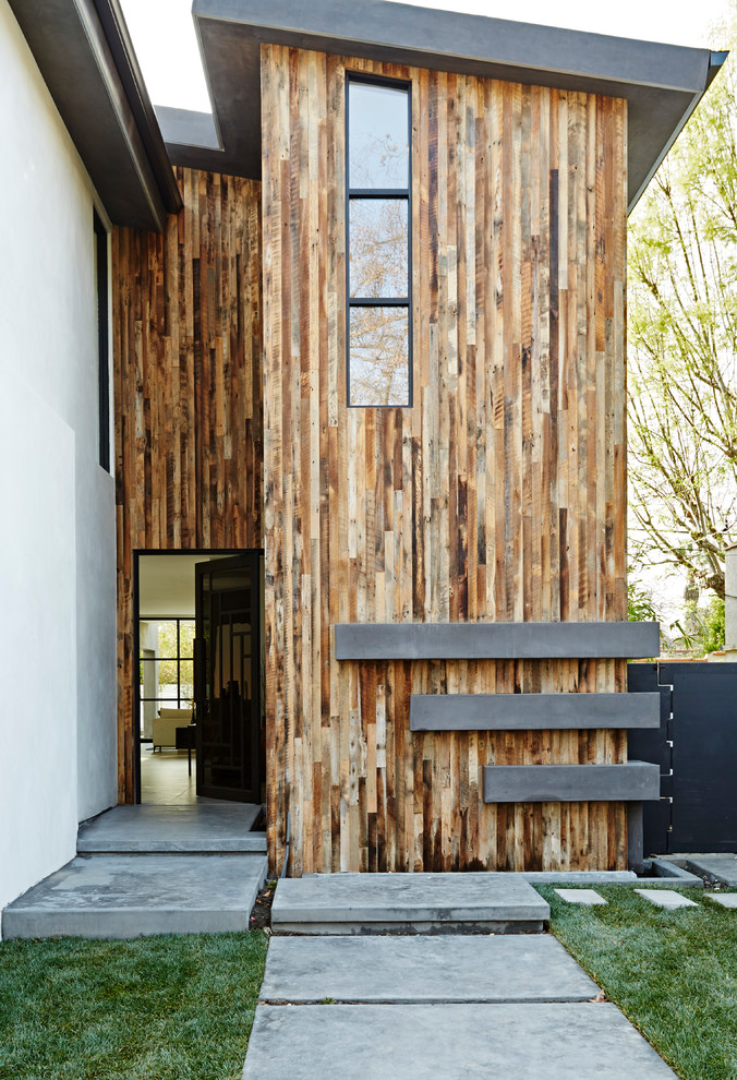 Photo of a contemporary exterior in Los Angeles with mixed siding and a shed roof.