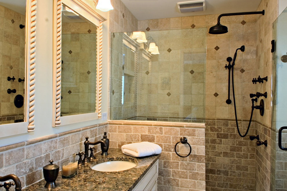 Mid-sized tuscan master beige tile and stone tile travertine floor alcove shower photo in New York with an undermount sink, furniture-like cabinets, beige cabinets, granite countertops, a two-piece toilet and beige walls