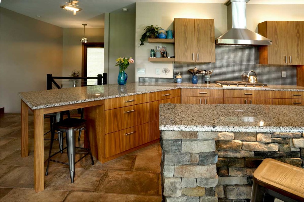 Inspiration for a large contemporary l-shaped eat-in kitchen in Philadelphia with an undermount sink, flat-panel cabinets, medium wood cabinets, granite benchtops, grey splashback, metal splashback, stainless steel appliances, ceramic floors, with island, beige floor and multi-coloured benchtop.