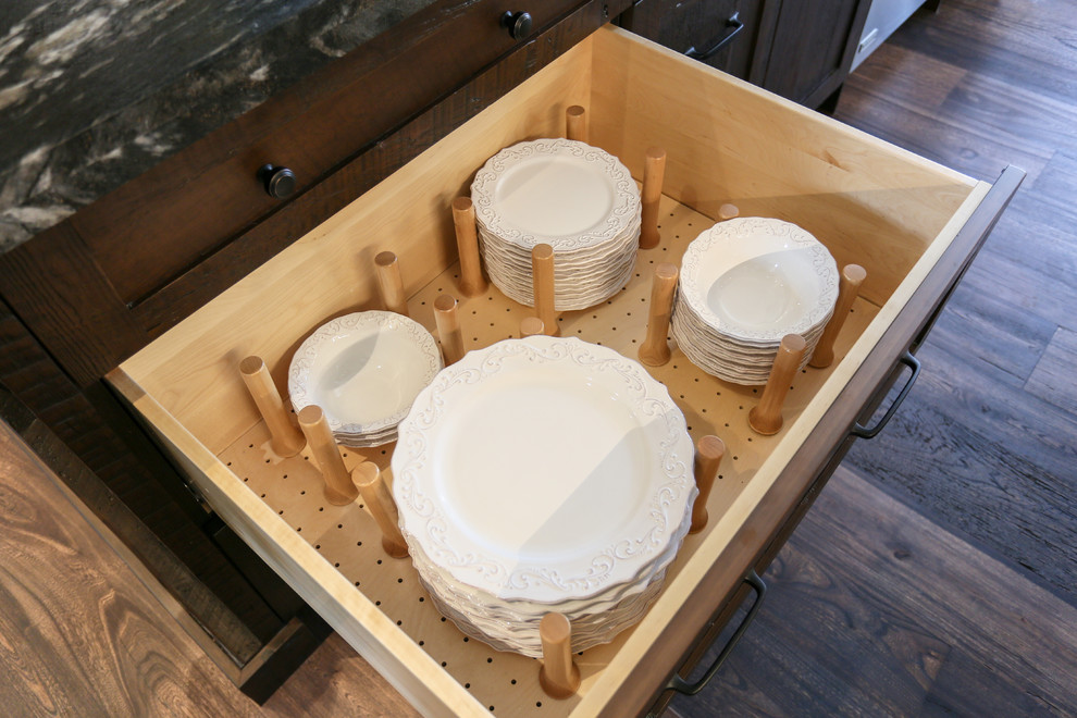 Large mountain style l-shaped dark wood floor and brown floor open concept kitchen photo in Toronto with an undermount sink, recessed-panel cabinets, white cabinets, beige backsplash, glass tile backsplash, stainless steel appliances, an island, onyx countertops and black countertops