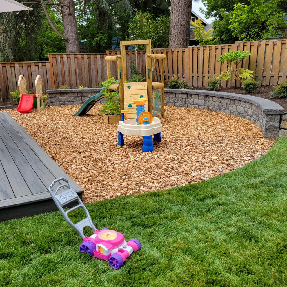 Inspiration for a large traditional backyard partial sun xeriscape for summer in Portland with with outdoor playset and decking.