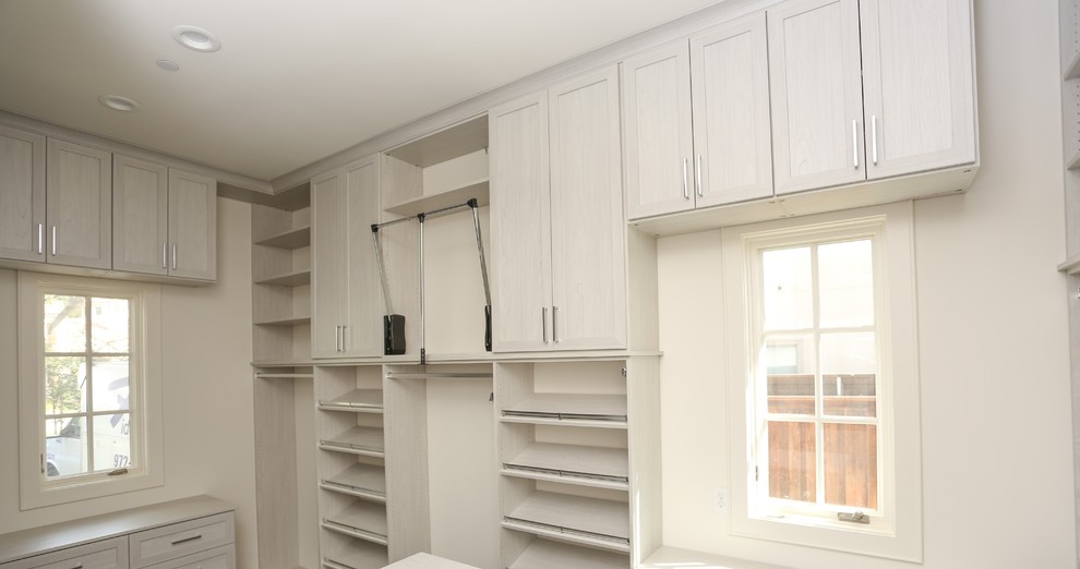 Design ideas for an expansive contemporary gender-neutral walk-in wardrobe in Atlanta with shaker cabinets, medium hardwood floors, brown floor and light wood cabinets.
