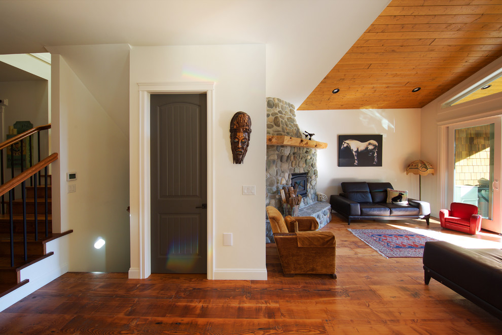 Inspiration for a small rustic formal and open concept medium tone wood floor living room remodel in Vancouver with white walls, a corner fireplace and a stone fireplace