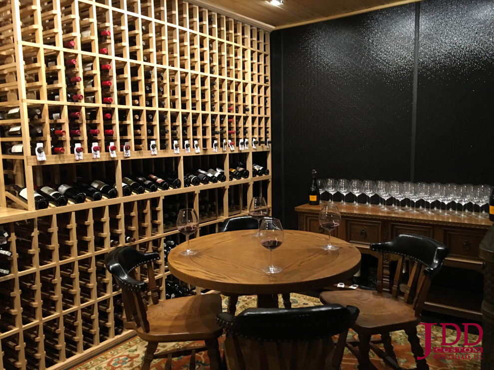 Photo of a large traditional wine cellar in Cincinnati with concrete floors and storage racks.