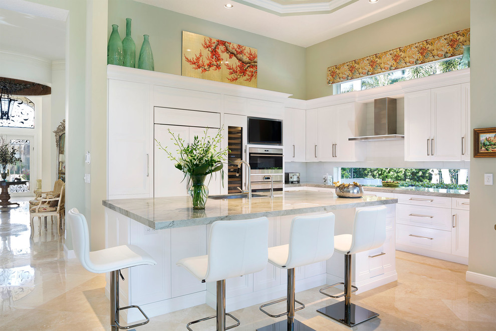 Mid-sized transitional l-shaped porcelain tile and beige floor eat-in kitchen photo in Miami with an undermount sink, recessed-panel cabinets, white cabinets, marble countertops, stainless steel appliances, an island and gray countertops