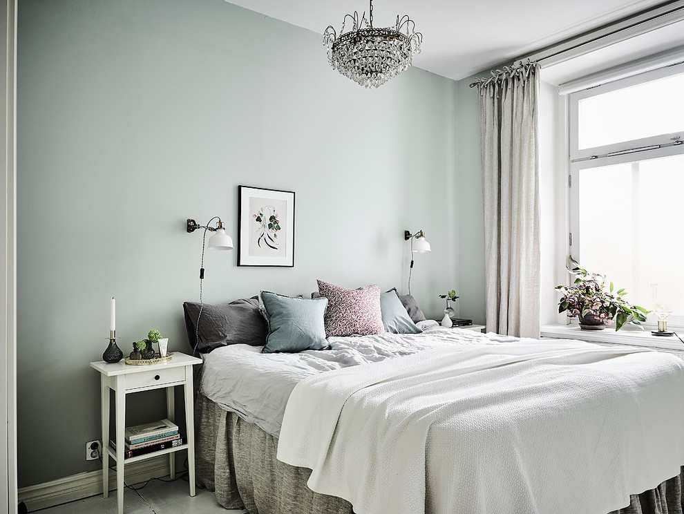 Design ideas for a mid-sized scandinavian master bedroom in Gothenburg with no fireplace and blue walls.