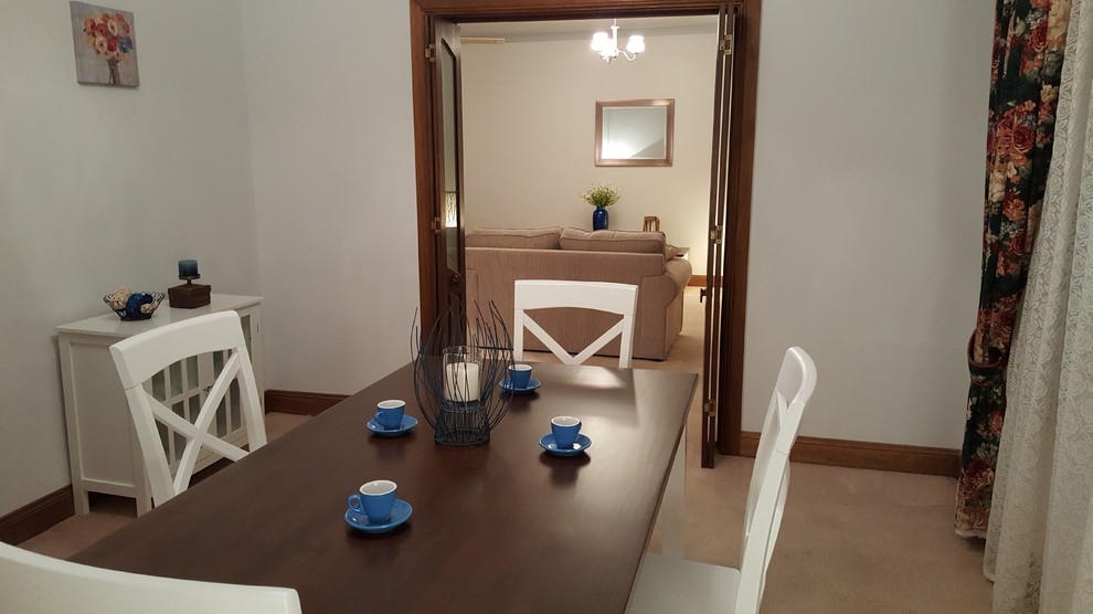 Photo of a traditional separate dining room in Adelaide with beige walls, carpet and beige floor.