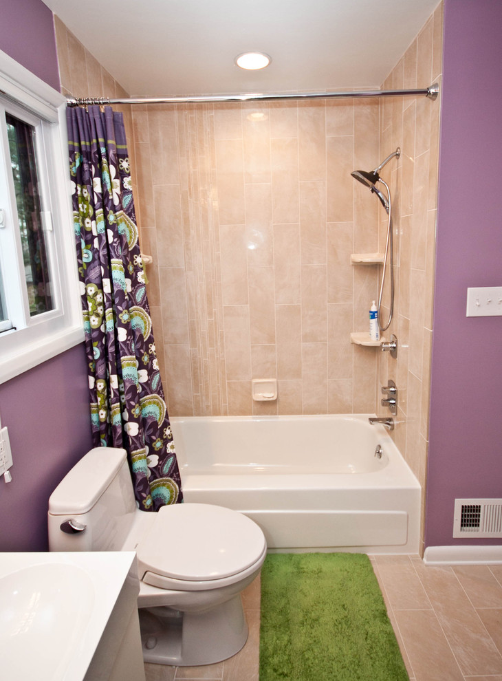 This is an example of a mid-sized contemporary kids bathroom in Baltimore with flat-panel cabinets, white cabinets, a drop-in tub, a shower/bathtub combo, a two-piece toilet, beige tile, porcelain tile, purple walls, porcelain floors, an integrated sink and laminate benchtops.
