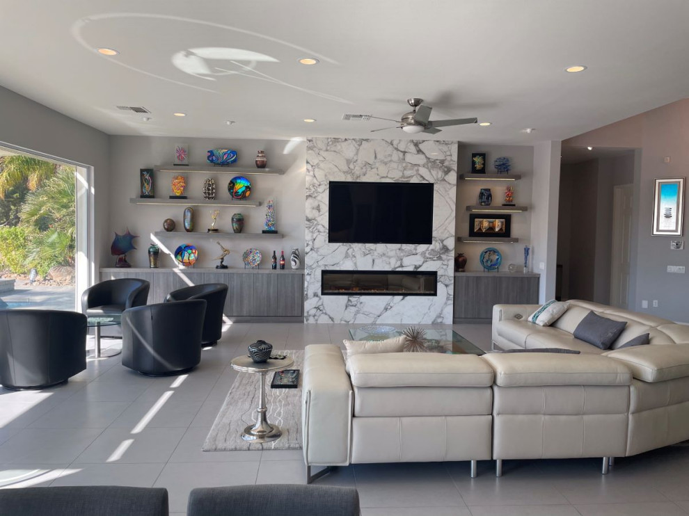 Photo of a mid-sized contemporary formal open concept living room in Other with grey walls, porcelain floors, a ribbon fireplace, a stone fireplace surround, a built-in media wall and white floor.