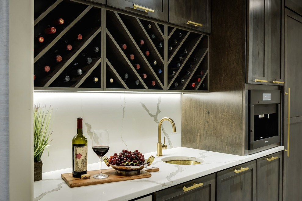 Inspiration for a small modern single-wall wet bar in New York with an undermount sink, shaker cabinets, dark wood cabinets, quartzite benchtops, white splashback, marble splashback and white benchtop.
