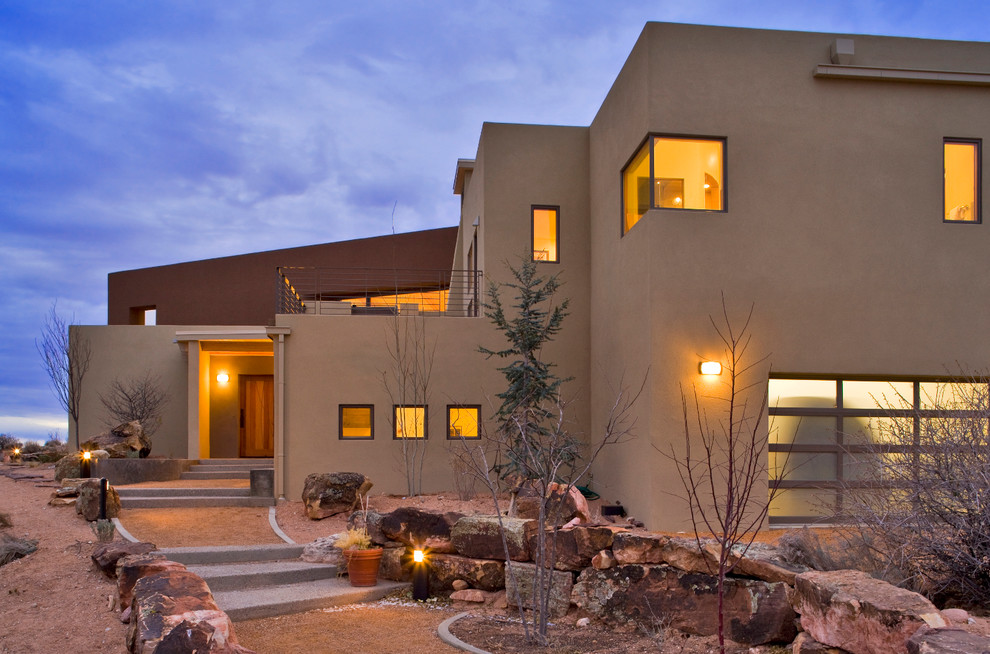 Photo of a large contemporary two-storey stucco brown exterior in Albuquerque.
