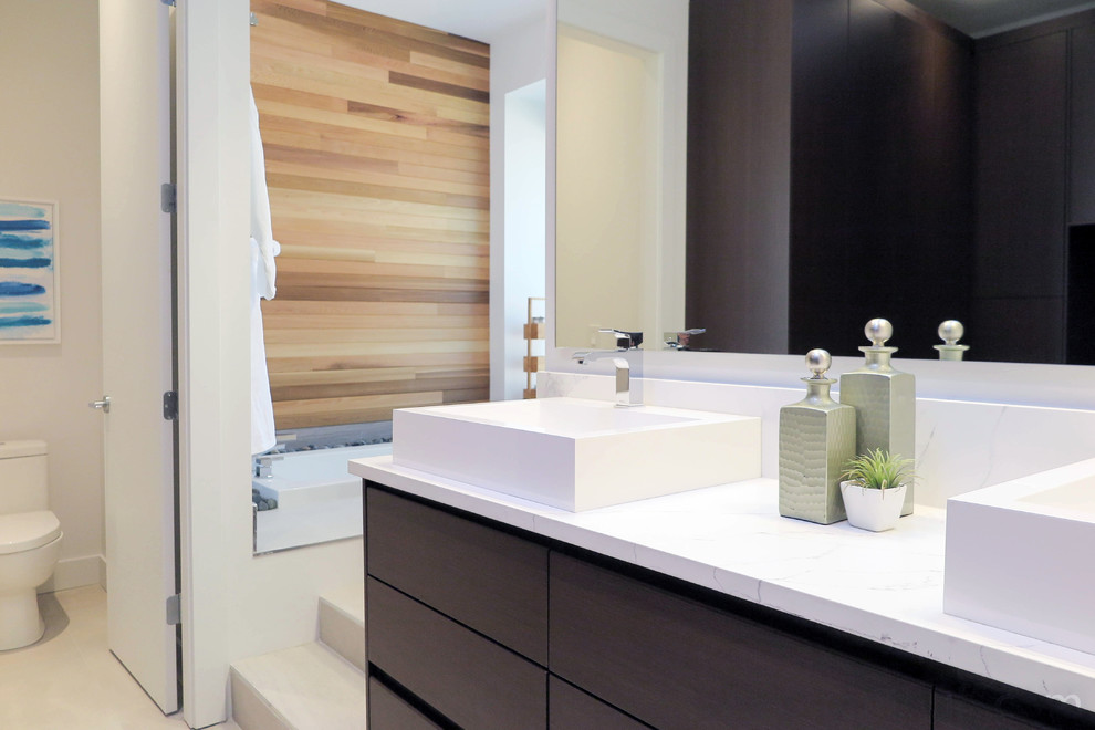 Inspiration for a mid-sized contemporary master bathroom in Vancouver with flat-panel cabinets, brown cabinets, an undermount tub, a curbless shower, a one-piece toilet, white tile, porcelain tile, a console sink, engineered quartz benchtops, grey floor, a hinged shower door and yellow benchtops.