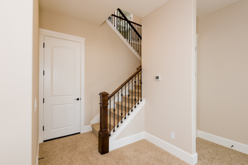 Design ideas for a large transitional carpeted u-shaped staircase in Portland with carpet risers.