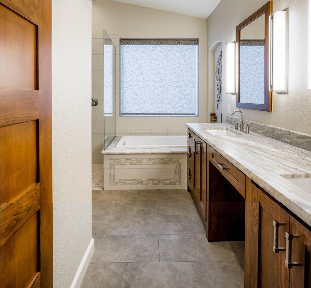 Inspiration for a mid-sized transitional master gray tile and porcelain tile porcelain tile and brown floor drop-in bathtub remodel in Phoenix with shaker cabinets, medium tone wood cabinets, a two-piece toilet, white walls, an undermount sink and granite countertops