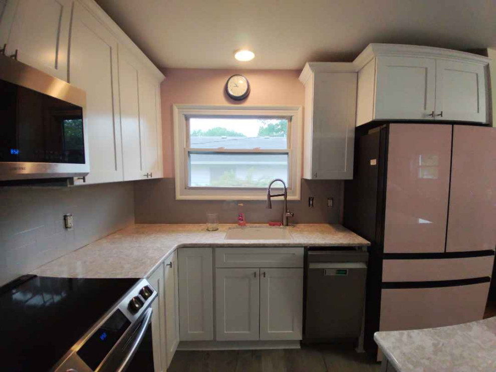 Mid-sized modern u-shaped eat-in kitchen in Other with grey cabinets, quartz benchtops, subway tile splashback and with island.