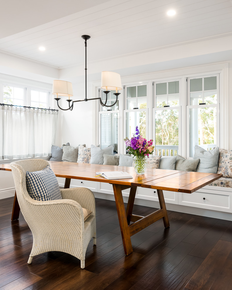 Design ideas for a beach style dining room in Gold Coast - Tweed with white walls, dark hardwood floors and brown floor.