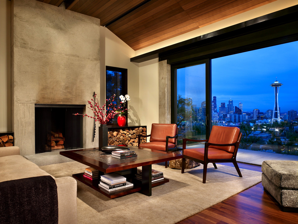 Photo of a mid-sized contemporary formal open concept living room in Seattle with a concrete fireplace surround, a standard fireplace, beige walls, medium hardwood floors, no tv and brown floor.