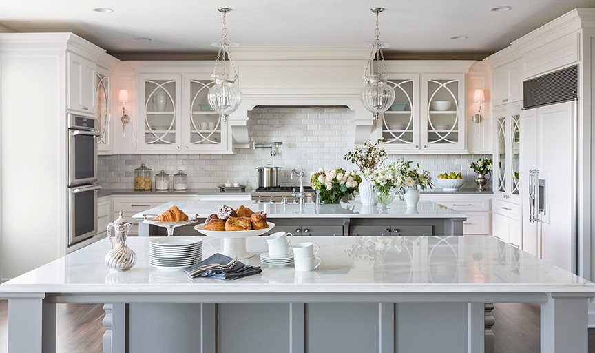 Large transitional u-shaped dark wood floor eat-in kitchen photo in Minneapolis with an undermount sink, recessed-panel cabinets, gray cabinets, marble countertops, white backsplash, stone tile backsplash, paneled appliances and two islands
