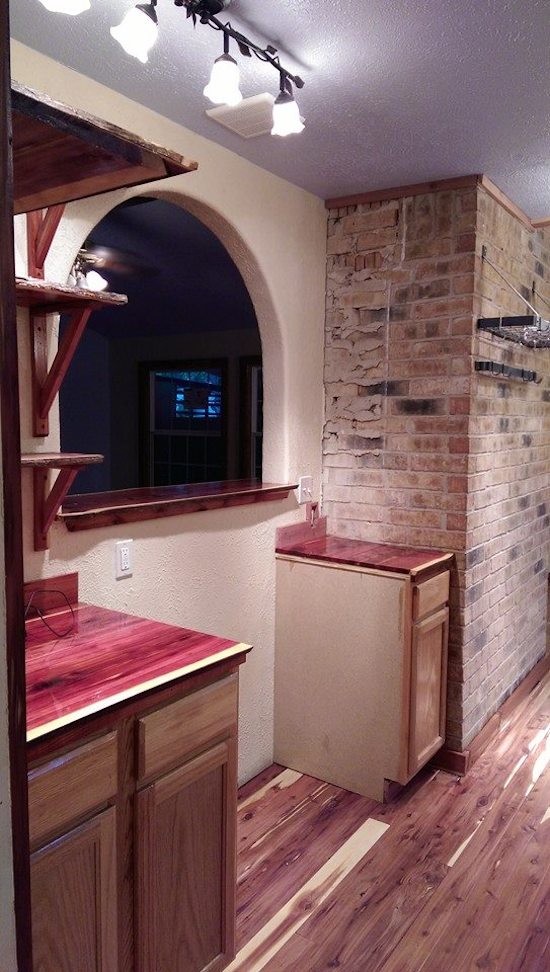 Mid-sized galley medium tone wood floor eat-in kitchen photo in Austin with a drop-in sink and no island