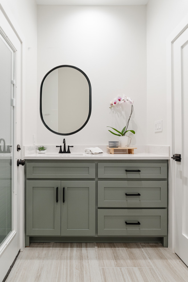 Small transitional 3/4 bathroom in Dallas with shaker cabinets, green cabinets, a double shower, a one-piece toilet, white walls, porcelain floors, an undermount sink, engineered quartz benchtops, beige floor, a sliding shower screen, white benchtops, a single vanity and a built-in vanity.
