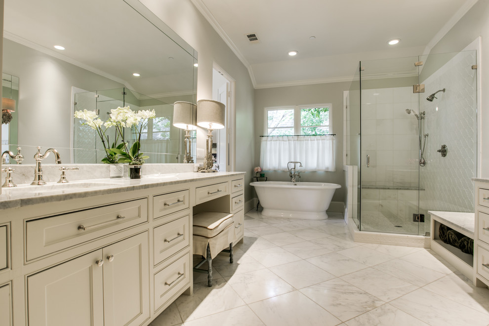 This is an example of an expansive traditional master bathroom in Dallas with beaded inset cabinets, white cabinets, marble benchtops, multi-coloured tile and stone tile.
