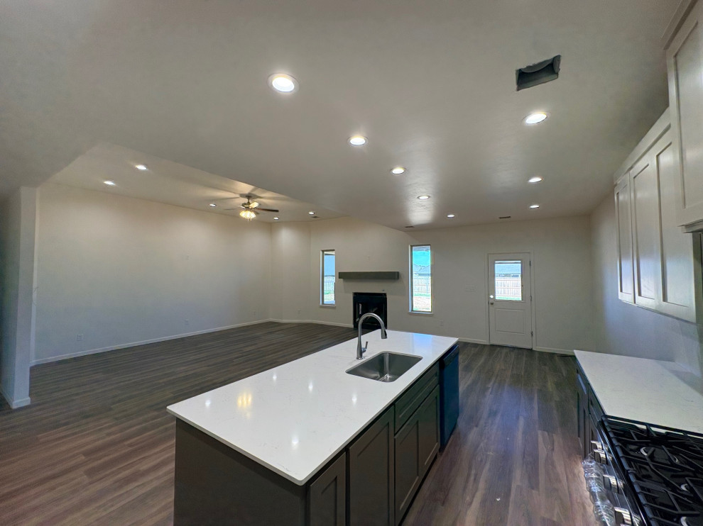 Under Construction- Broad view of the living room, kitchen and dining area