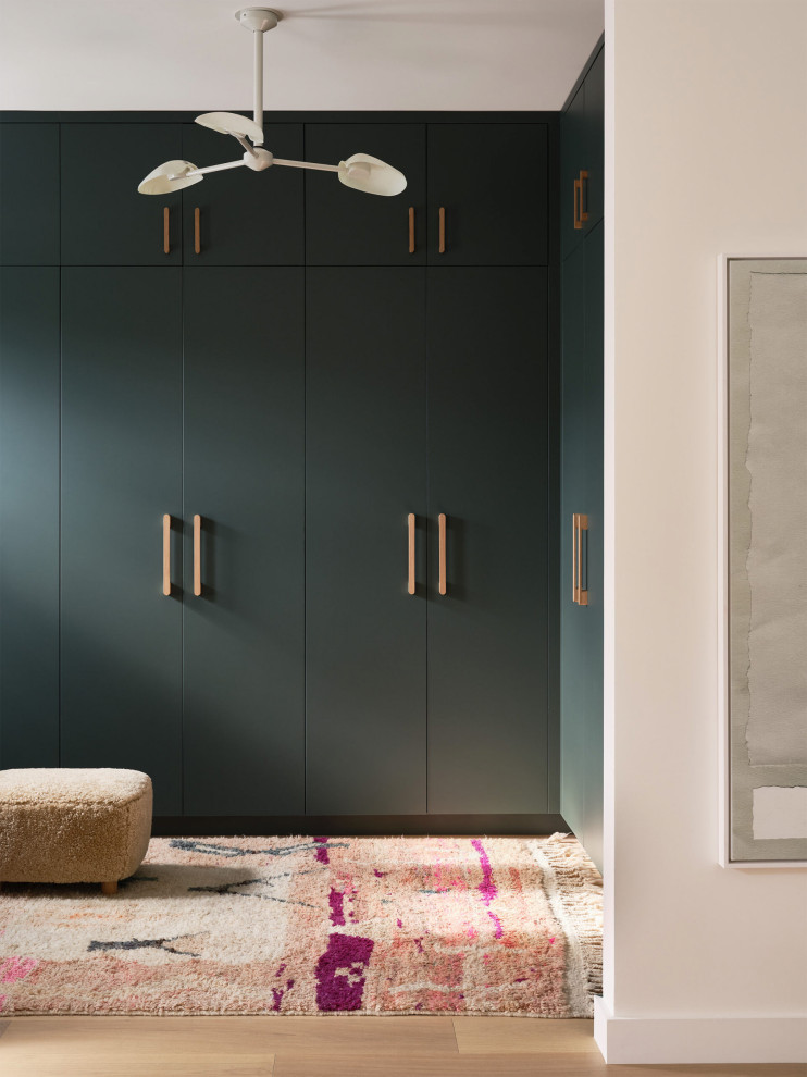 Walk-in closet - contemporary light wood floor and beige floor walk-in closet idea in San Francisco with flat-panel cabinets and green cabinets