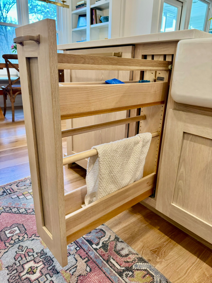 Eat-in kitchen - mid-sized transitional l-shaped light wood floor, brown floor and wallpaper ceiling eat-in kitchen idea in Atlanta with a farmhouse sink, shaker cabinets, white cabinets, granite countertops, white backsplash, stainless steel appliances, an island and white countertops