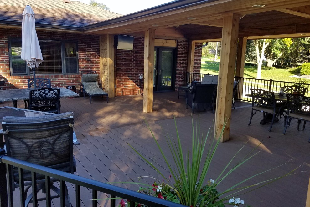 Inspiration for a large backyard deck remodel with a roof extension