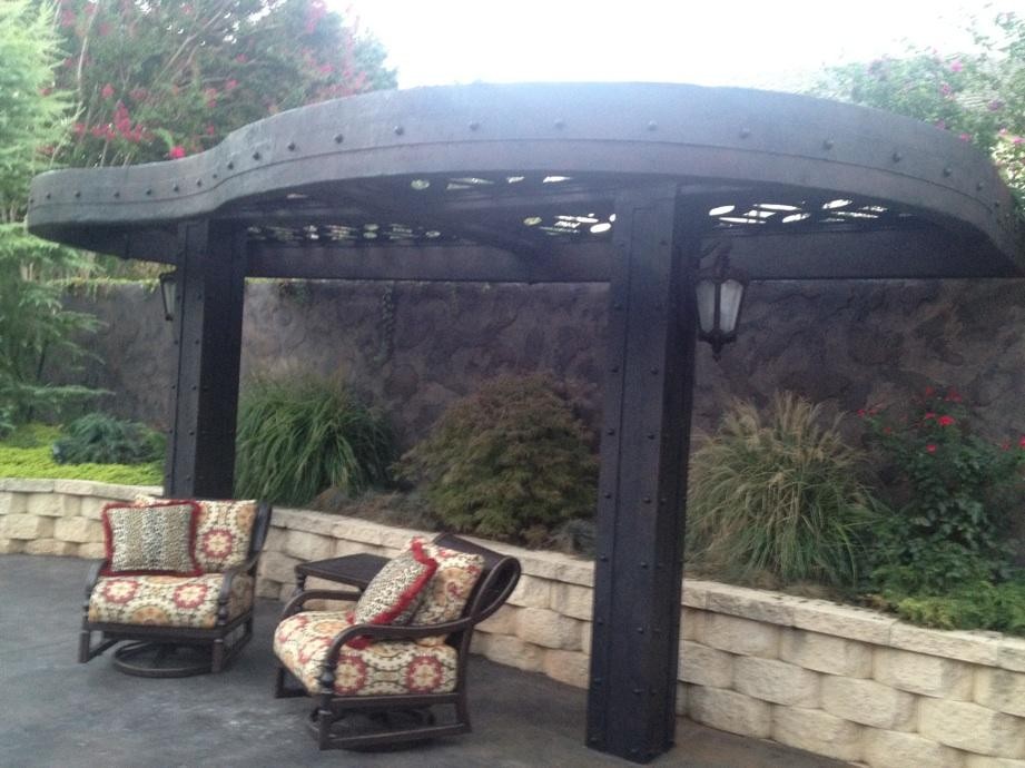 This is an example of a mid-sized eclectic patio in Oklahoma City with a pergola.