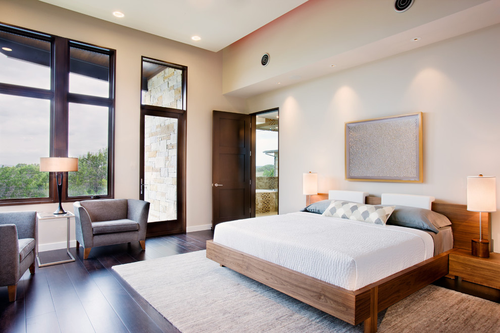 Design ideas for an expansive contemporary master bedroom in Austin with beige walls, dark hardwood floors, no fireplace and brown floor.