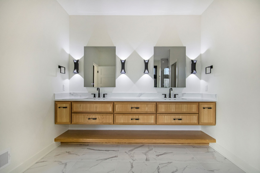 Inspiration for a large modern ensuite bathroom in Grand Rapids with light wood cabinets, white walls, porcelain flooring, a submerged sink, engineered stone worktops, white floors, white worktops, double sinks and a floating vanity unit.