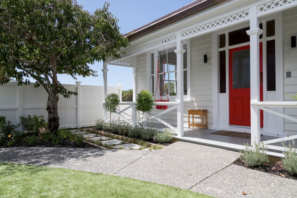 Design ideas for a large contemporary front door in Auckland with white walls, a single front door and a red front door.