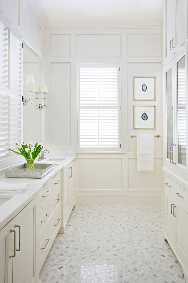 Beach style bathroom in Charleston with recessed-panel cabinets, beige cabinets, an undermount sink, white floor and white benchtops.