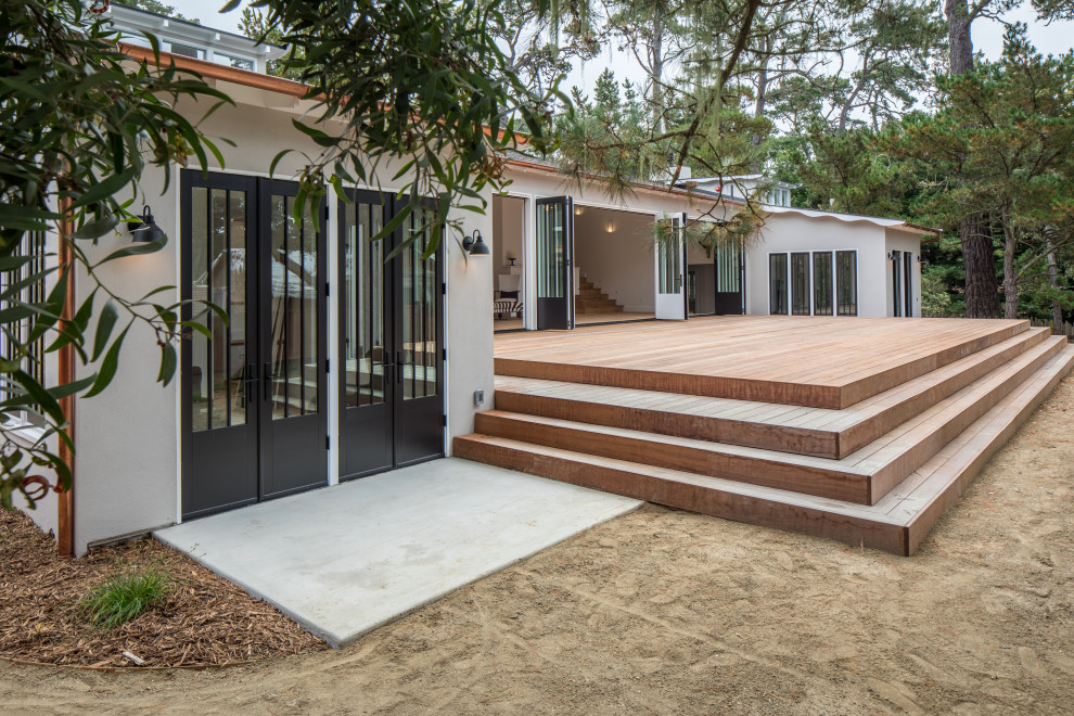 Large transitional beige split-level stucco house exterior idea with a hip roof and a shingle roof