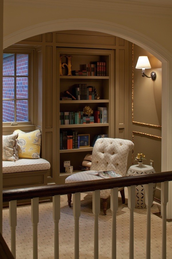 This is an example of a large traditional loft-style living room in DC Metro with a library, brown walls, carpet, no fireplace, no tv and beige floor.