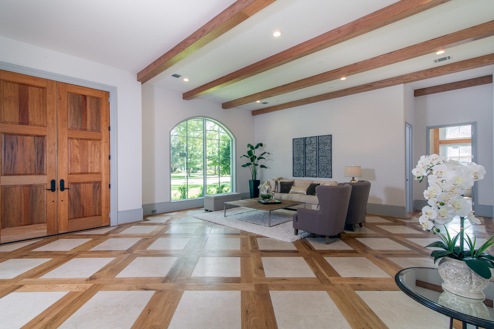 Expansive traditional foyer in Houston with white walls, a double front door, a medium wood front door and limestone floors.