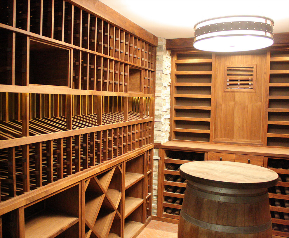 Photo of a mid-sized arts and crafts wine cellar in Los Angeles with brick floors and storage racks.