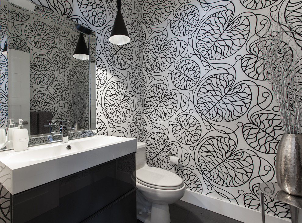 Inspiration for a contemporary bathroom in Other with an integrated sink, a one-piece toilet and multi-coloured walls.