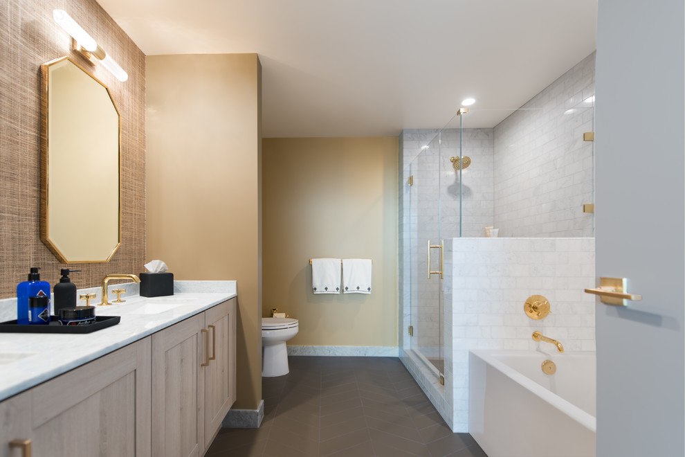 Photo of a mid-sized contemporary master bathroom in San Francisco with shaker cabinets, grey cabinets, a drop-in tub, a corner shower, a one-piece toilet, gray tile, marble, beige walls, cement tiles, an undermount sink, marble benchtops, grey floor, a hinged shower door and grey benchtops.