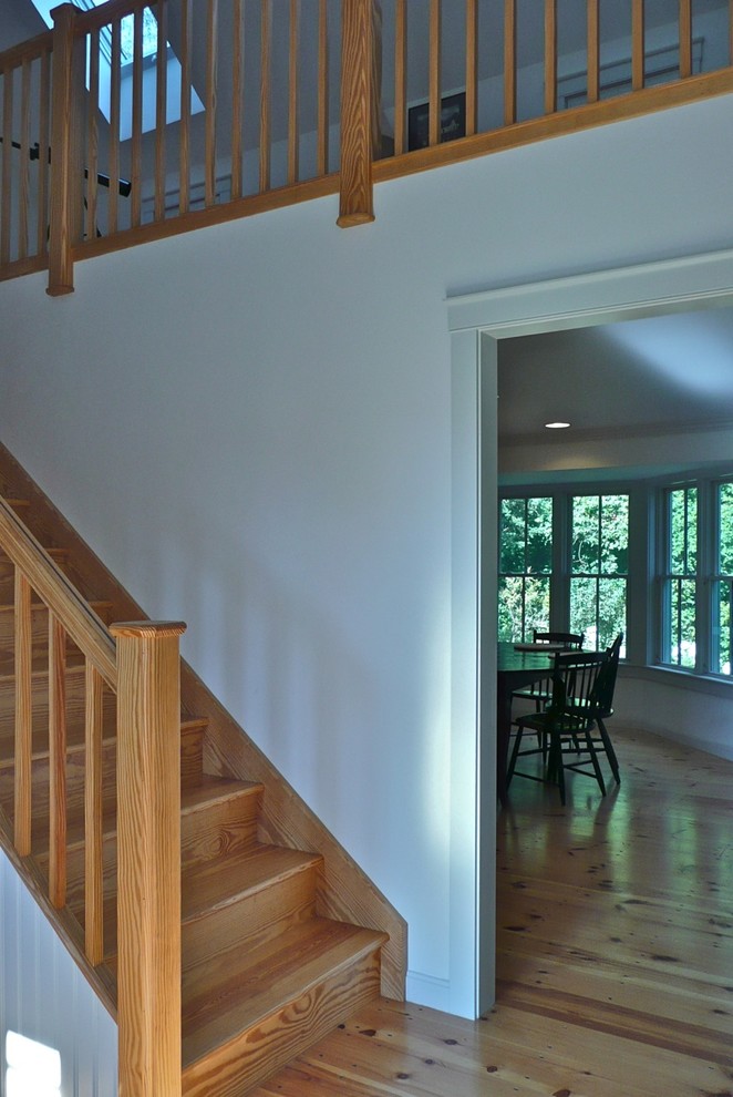 Mid-sized transitional wood straight staircase in Boston with wood risers and wood railing.