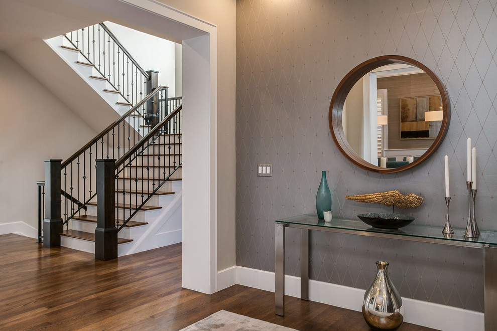 Inspiration for a mid-sized transitional hallway in Denver with multi-coloured walls, dark hardwood floors and brown floor.