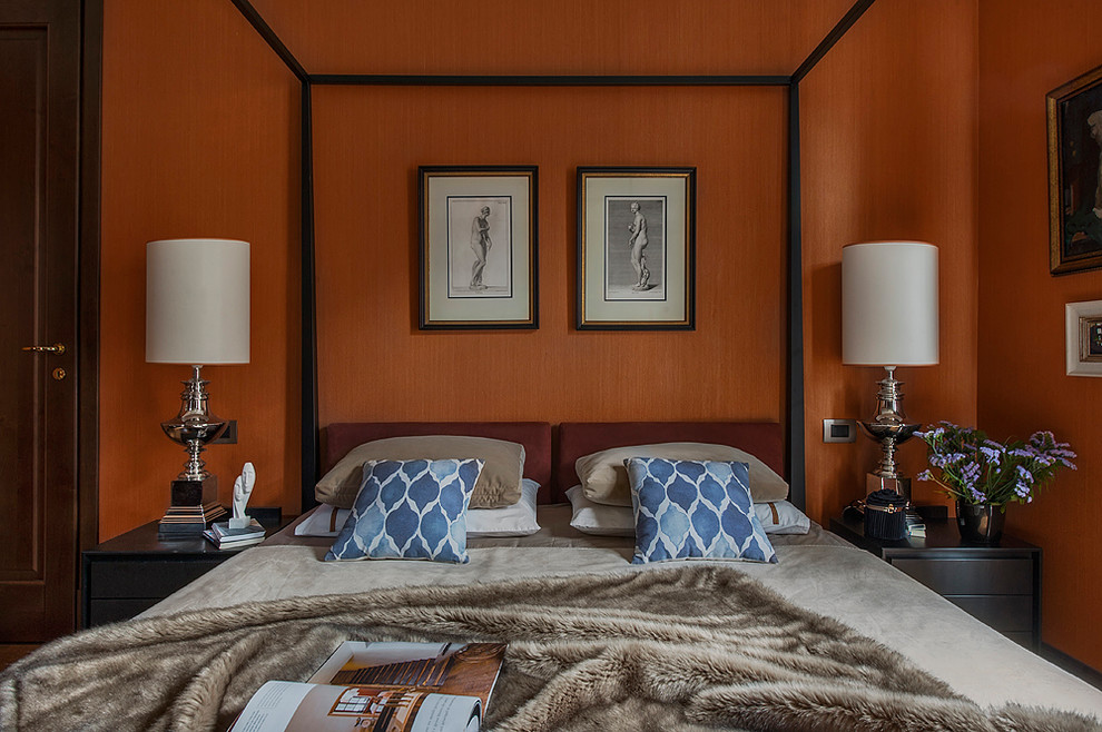 This is an example of an eclectic master bedroom in Moscow with orange walls.
