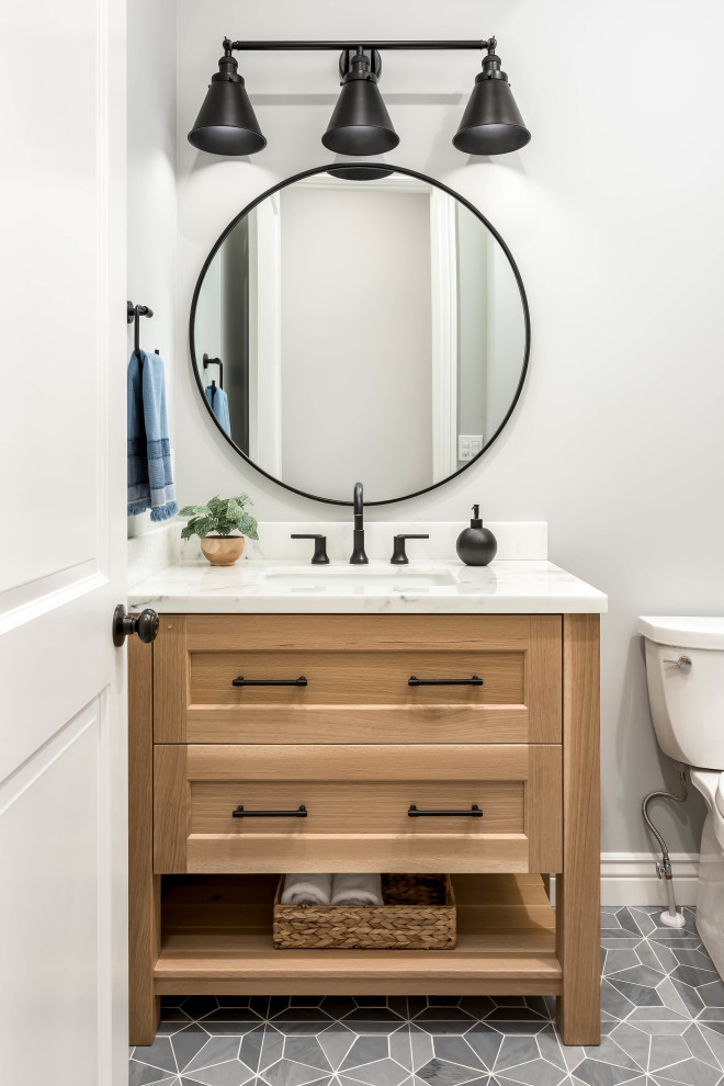 Small cloakroom in Salt Lake City with recessed-panel cabinets, light wood cabinets, a two-piece toilet, marble flooring, a submerged sink, marble worktops, blue floors, white worktops and a built in vanity unit.