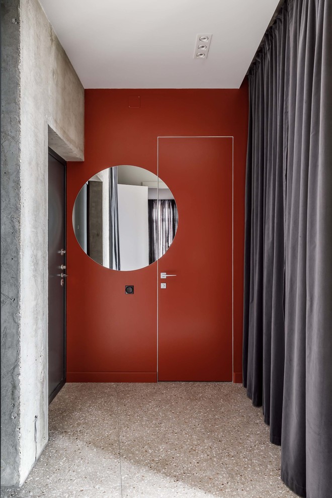 Photo of a contemporary front door in Other with orange walls, terrazzo floors, a single front door, a black front door and grey floor.