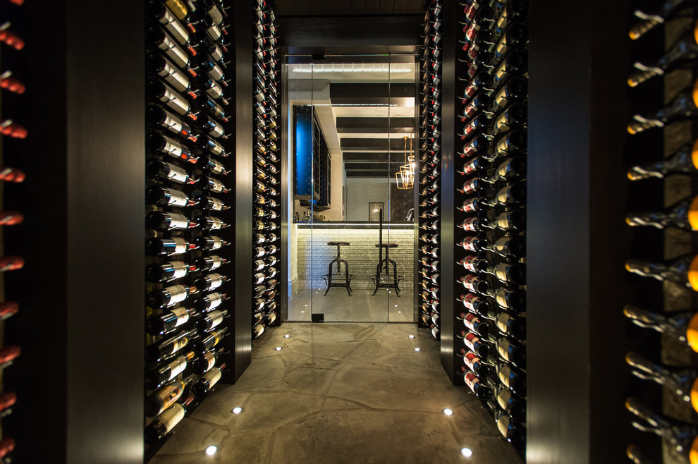 Inspiration for a transitional wine cellar in Vancouver with display racks and grey floor.